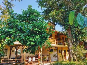 a building with trees in front of it at Canto do Riacho Suites in Trindade