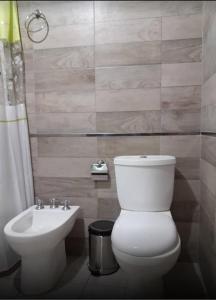 a bathroom with a toilet and a sink at LA CABAÑA in Termas de Río Hondo +17 photos