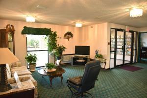 a living room with a couch and a chair at Super 8 by Wyndham Springfield-Battlefield in Springfield