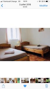 two beds in a small room with at A FATA DI L'ORTOLO gîtes à la ferme in Sartène