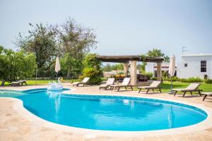a swimming pool with chairs and a gazebo at CAN FARITZEO in Sant Rafael de Sa Creu