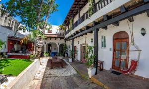 a courtyard of a house with a table and benches at Island Life Hostel in Santo Domingo