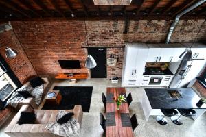 an overhead view of a living room with a brick wall at The Terminus in Dunedin