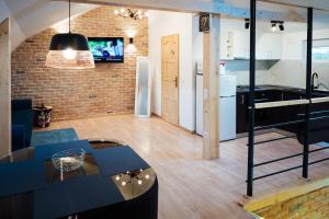 a kitchen and living room with a brick wall at Belle View Apart Hotel in Turda