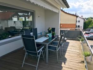 a table and chairs sitting on a balcony at Haus Mozartstraße in Mutlangen