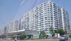 a large white building with cars in front of it at Condo C9 IMPACT in Pak Kret