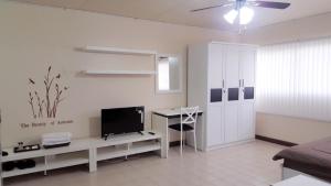 a white living room with a television and a desk at Popular Condo C9 in Pak Kret