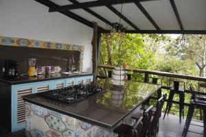 a kitchen with a stove and a table on a balcony at Casa La Maria Salento, 3 HABITACIONES in Salento