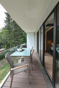 une table et des chaises sur le balcon d'une maison dans l'établissement White Pearl Apartment 1.03, à Timmendorfer Strand