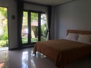 Postel nebo postele na pokoji v ubytování Bali Full Moon Guest House