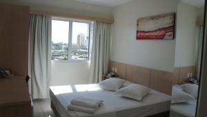 En eller flere senge i et værelse på Savana Hotel