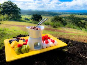 a tray of fruit and a drink on a table at Mt Quincan Crater Retreat in Yungaburra