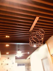 a chandelier hanging from a ceiling in a room at Luzville Residences - C5 in Naic