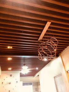 a chandelier hanging from a ceiling in a room at Luzville Residences - C5 in Naic +4 photos