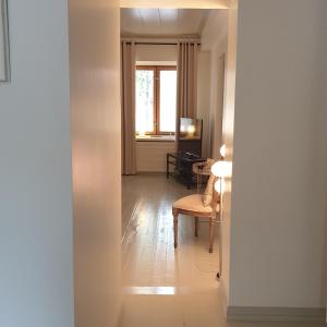 a hallway with a chair and a table and a window at Porvoo City Apartments in Porvoo