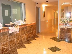 a lobby of a building with a counter with flowers at Hotel GOLF Hodogaya (Adult Only) in Yokohama