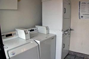 a laundry room with white appliances in a room at Motel 6-McKinney, TX - North in McKinney
