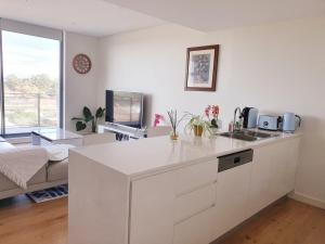 a kitchen with a white counter top in a room at Macquarie Park Paradise-City View in Sydney