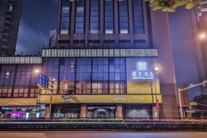 a building with a sign on the side of it at SSAW Boutique Hotel Shanghai Bund in Shanghai