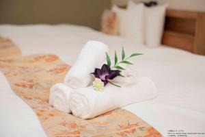 Ένα ή περισσότερα κρεβάτια σε δωμάτιο στο Stay SAKURA Kyoto Station South I +29 φωτογραφίες