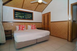 a bedroom with a bed and a ceiling fan at Island Magic Resort Apartments in Port Vila +32 photos