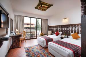 A bed or beds in a room at Hotel Manaslu
