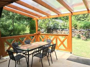 a patio with a table and chairs on a deck at Erdő Kapitánya Vendégház in Tata +12 photos