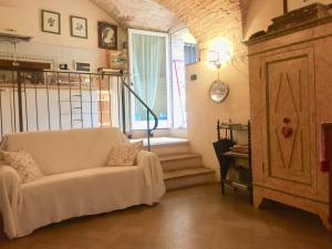 a living room with a white couch and a window at LA GUARDIOLA DEL TEMPIO in Perugia