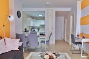 a living room and kitchen with a table and chairs at Home Sweet Home with Ocean View in Costa Calma