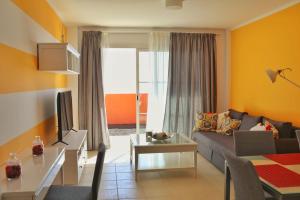 a living room with a couch and a table at Home Sweet Home with Ocean View in Costa Calma
