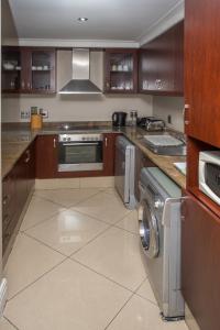 a kitchen with a washer and dryer in it at Stay at The Point - Seaside Saunter in Durban