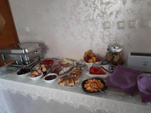 a table with many plates of food on it at Kalina Family Hotel in Burgas
