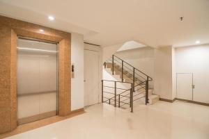 a hallway with a staircase and a glass door at Hotel Yehezkiel Surapati Mitra RedDoorz in Bandung
