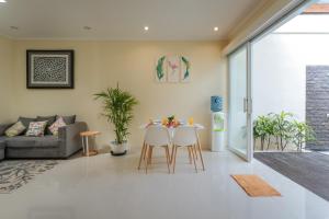 ein Wohnzimmer mit Tisch und Stühlen in der Unterkunft Villa Julie & Villa Sydney, Seminyak - 2 Bedroom Modern Pool Villas! in Seminyak