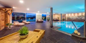 a living room with a swimming pool in a house at Villa Residence Franziskus in Tirolo