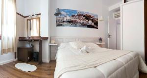 a bedroom with a large white bed and a window at Hostal Ibiza in Ibiza Town