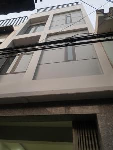 a white building with a window on the side of it at xh apartment in Danang +7 photos