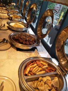 un buffet avec plusieurs plateaux de nourriture sur une table dans l'établissement Shenzhen Lido Hotel, à Shenzhen