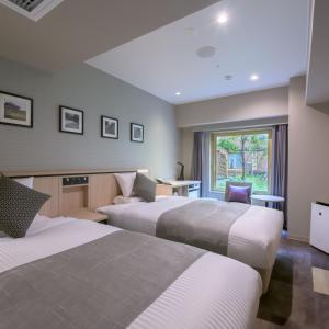 a hotel room with two beds and a window at Nara Royal Hotel in Nara