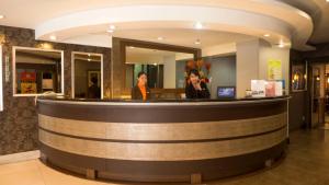 two people standing at a wine bar at Rothman Hotel in Manila