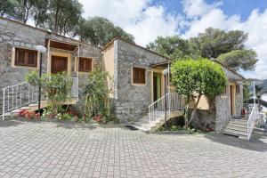 a stone house with stairs leading up to it at Residence Vacanza Mare in Campo nell'Elba
