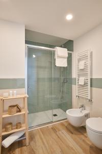 a bathroom with a shower and a toilet and a sink at Agriturismo Casastella in Ceriale