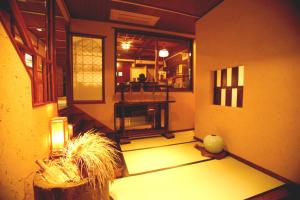 a room with a wooden floor and a large window at Masutomi Ryokan in Hakone