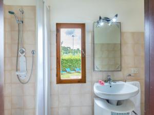 a bathroom with a sink and a mirror and a shower at La Pergola in Monticiano +16 photos