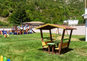 a playground with a wooden pavilion in a park at Thassos Grand Resort in Alyki