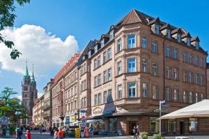 a large brick building on a city street at Gideon Hotel in Nürnberg