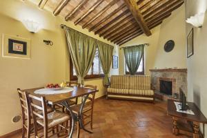 a dining room with a table and a fireplace at La Coppa in Asciano