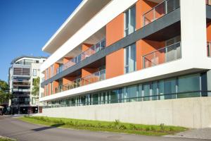 an orange and white building on the side of a street at Riverside Apartment in Pärnu