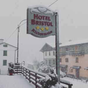a sign for a hotel in the snow at Hotel Bristol in Fiumalbo