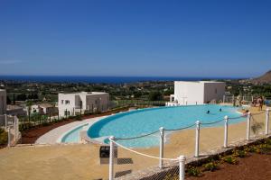 a large swimming pool with people in it at Villa Vitruvio - Giardino degli Allori Scopello in Castellammare del Golfo